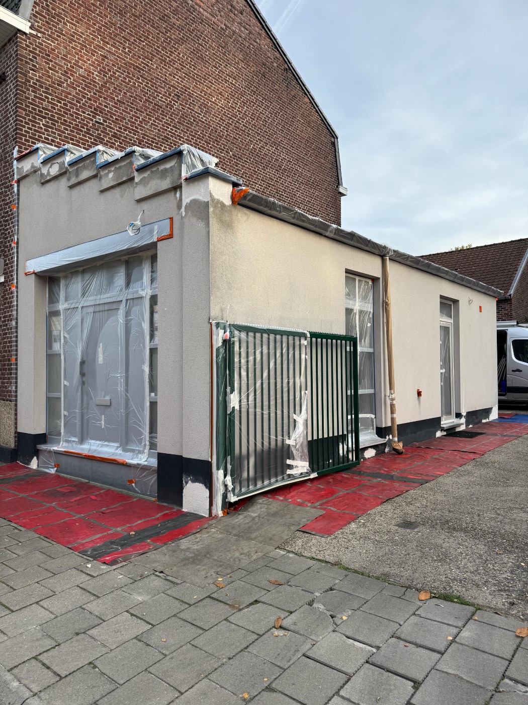 Gevel tijdens de voorbereiding: alles zorgvuldig afgeplakt en afgedekt